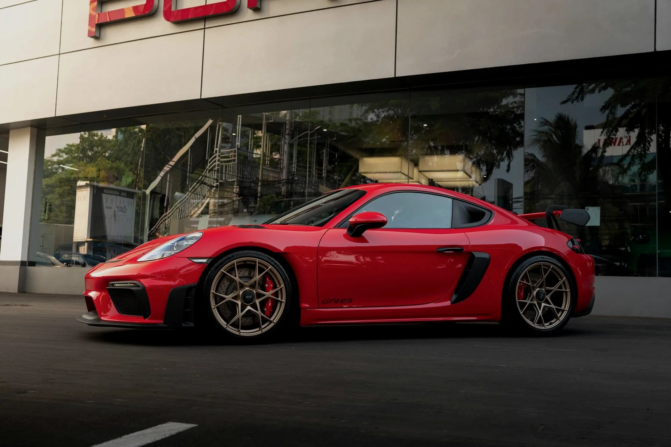 Red Porsche 718 Cayman GT4 RS in side profile