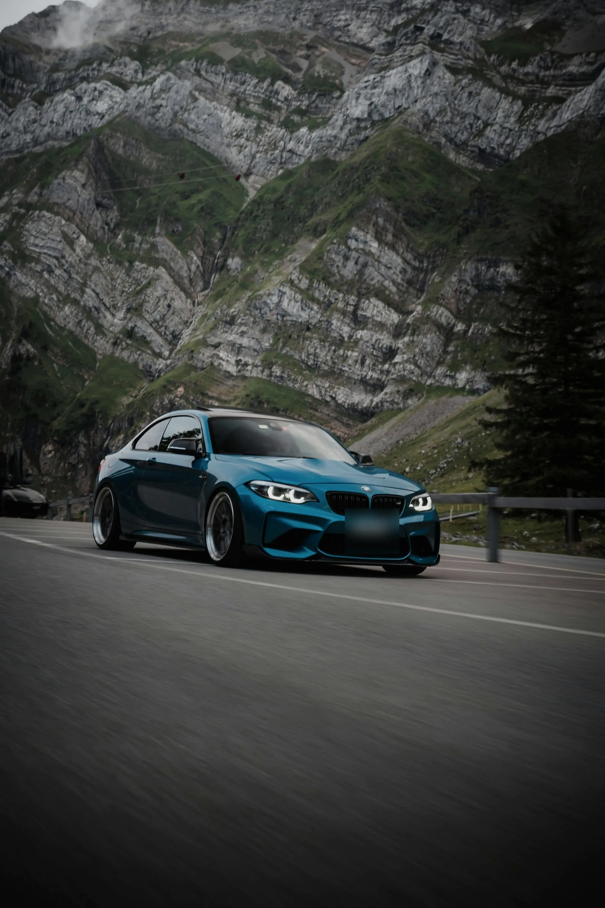 Blue BMW M2 Competition on a mountain road