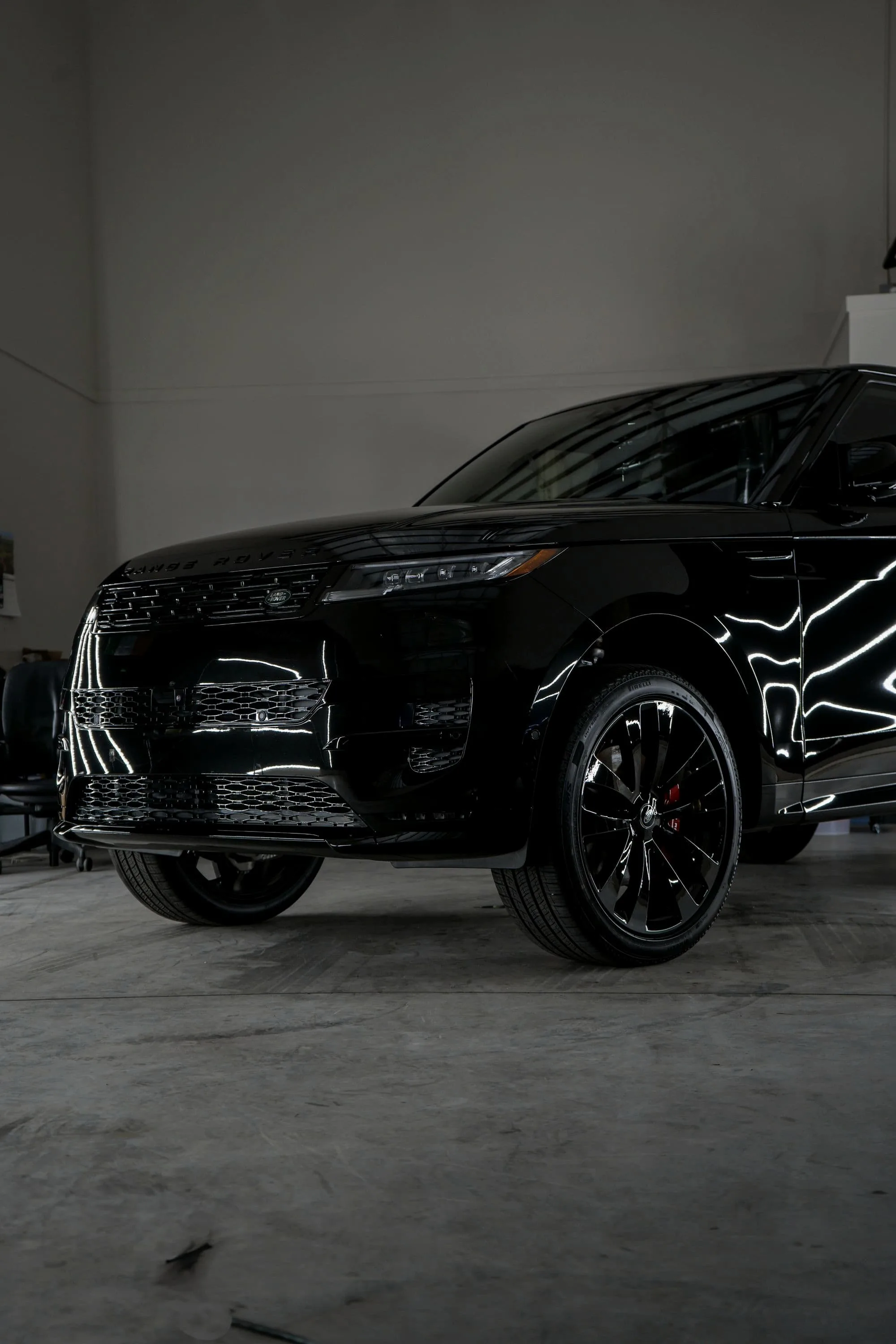Black Range Rover Sport SV with strip lights reflected across its flanks